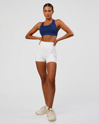Woman wearing Stability High Support Sports Bra - Midnight Blue | Model:Charli | Size:XS (A-C Cup)