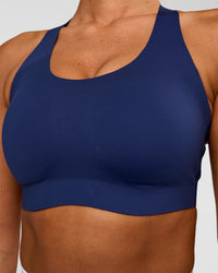Woman wearing Stability High Support Sports Bra - Midnight Blue | Model:Charli | Size:XS (A-C Cup)