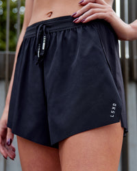 Woman wearing Accelerate 3" High-Rise Running Short - Black | Model:Lucinda | Size:XS