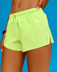 Woman wearing Accelerate 3" Running Short - Lime Glo | Model:Txai | Size:XS