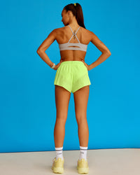 Woman wearing Accelerate 3" Running Short - Lime Glo-Shale Beige | Model:Steph | Size:XS