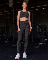 Woman wearing Accelerate Split Strap Sports Bra - Black Tie Dye | Model:Chloe | Size:XS