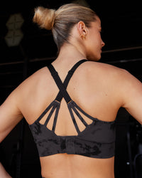 Woman wearing Accelerate Split Strap Sports Bra - Black Tie Dye | Model:Chloe | Size:XS