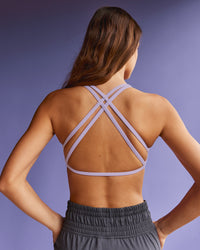 Woman wearing Aspire Twist Sports Bra - Pale Lilac | Model:Beatriz | Size:XS