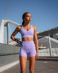 Woman wearing Elixir Ultra High-Rise 4" Short - Violet Ray | Model:Txai | Size:XS