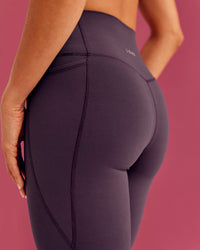 Woman wearing Elixir Ultra High-Rise Full Length Legging Pockets - Midnight Plum | Model:Bruna | Size:XS