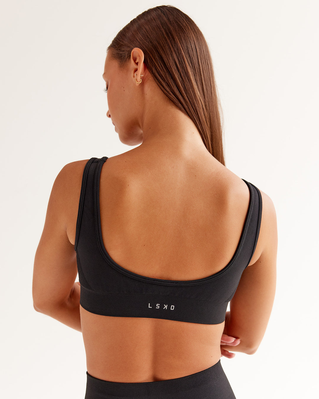 Woman wearing Ember Seamless Sports Bra - Black | Model:Brylee | Size:XS