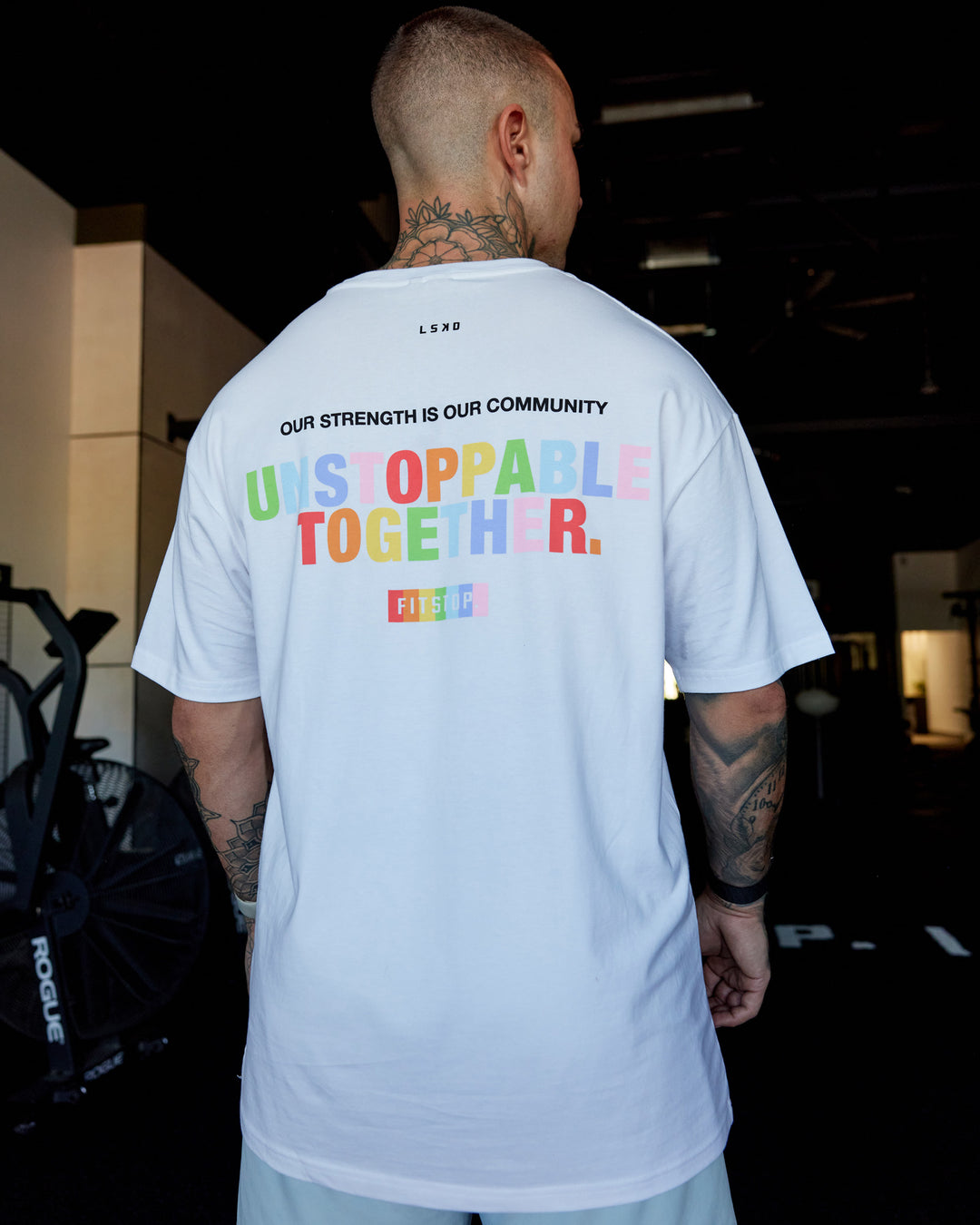 Man wearing Fitstop Unstoppable Together FLXCotton Oversize Tee - White | Model:Tayden | Size:XS