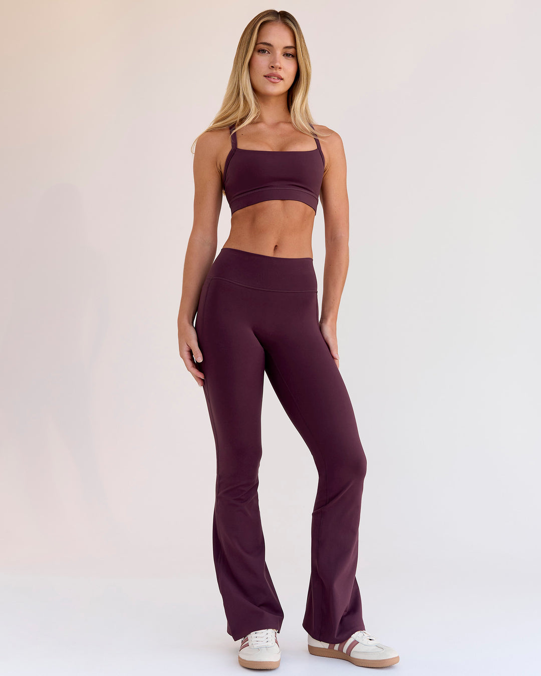 Woman wearing Fusion V-Contour High-Rise Flared Petite Legging Pockets - Cherry Lacquer | Model:Issy | Size:XS