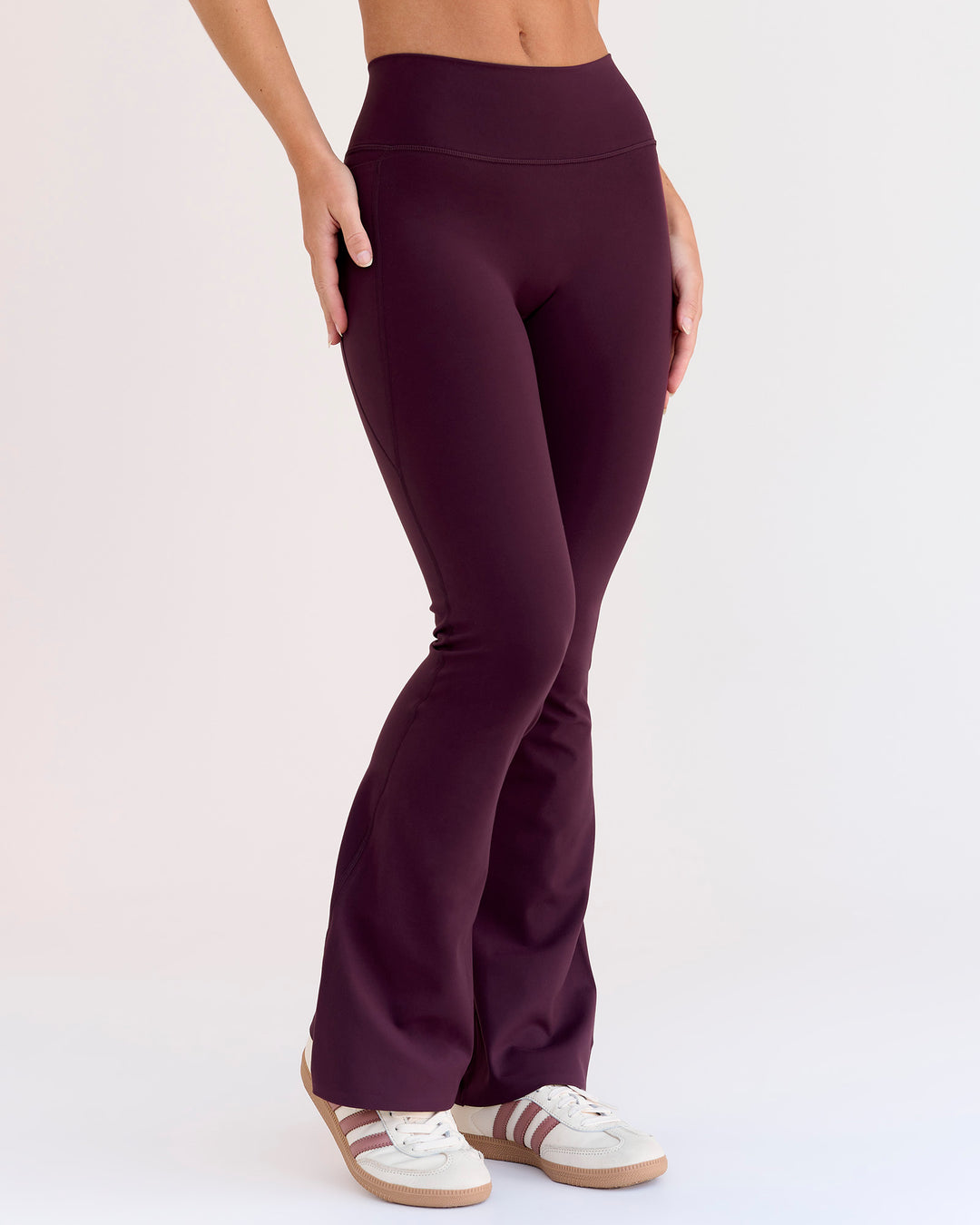 Woman wearing Fusion V-Contour High-Rise Flared Petite Legging Pockets - Cherry Lacquer | Model:Issy | Size:XS
