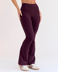 Woman wearing Fusion V-Contour High-Rise Flared Petite Legging Pockets - Cherry Lacquer | Model:Issy | Size:XS
