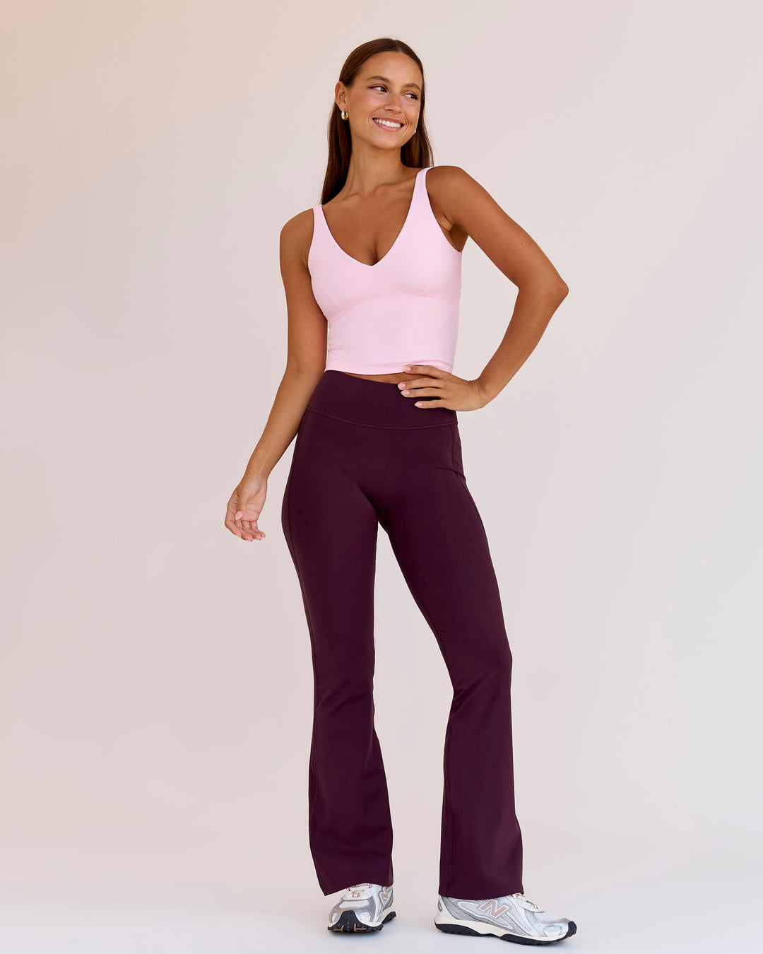 Woman wearing Fusion V-Contour High-Rise Flared Petite Legging Pockets - Cherry Lacquer | Model:Brylee | Size:XS