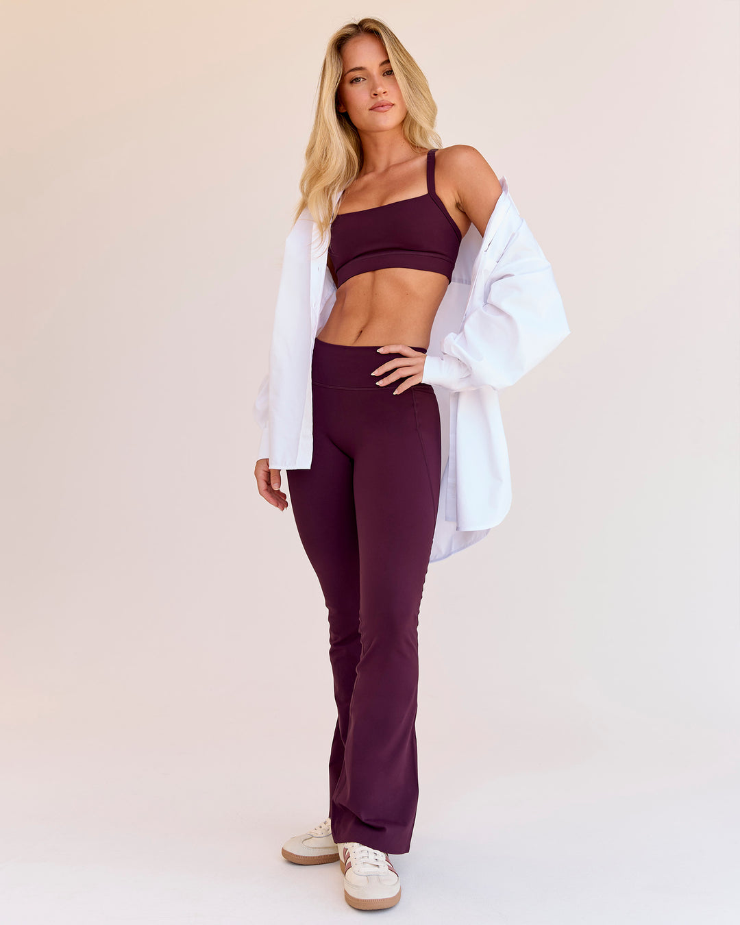 Woman wearing Fusion V-Contour High-Rise Flared Petite Legging Pockets - Cherry Lacquer | Model:Issy | Size:XS