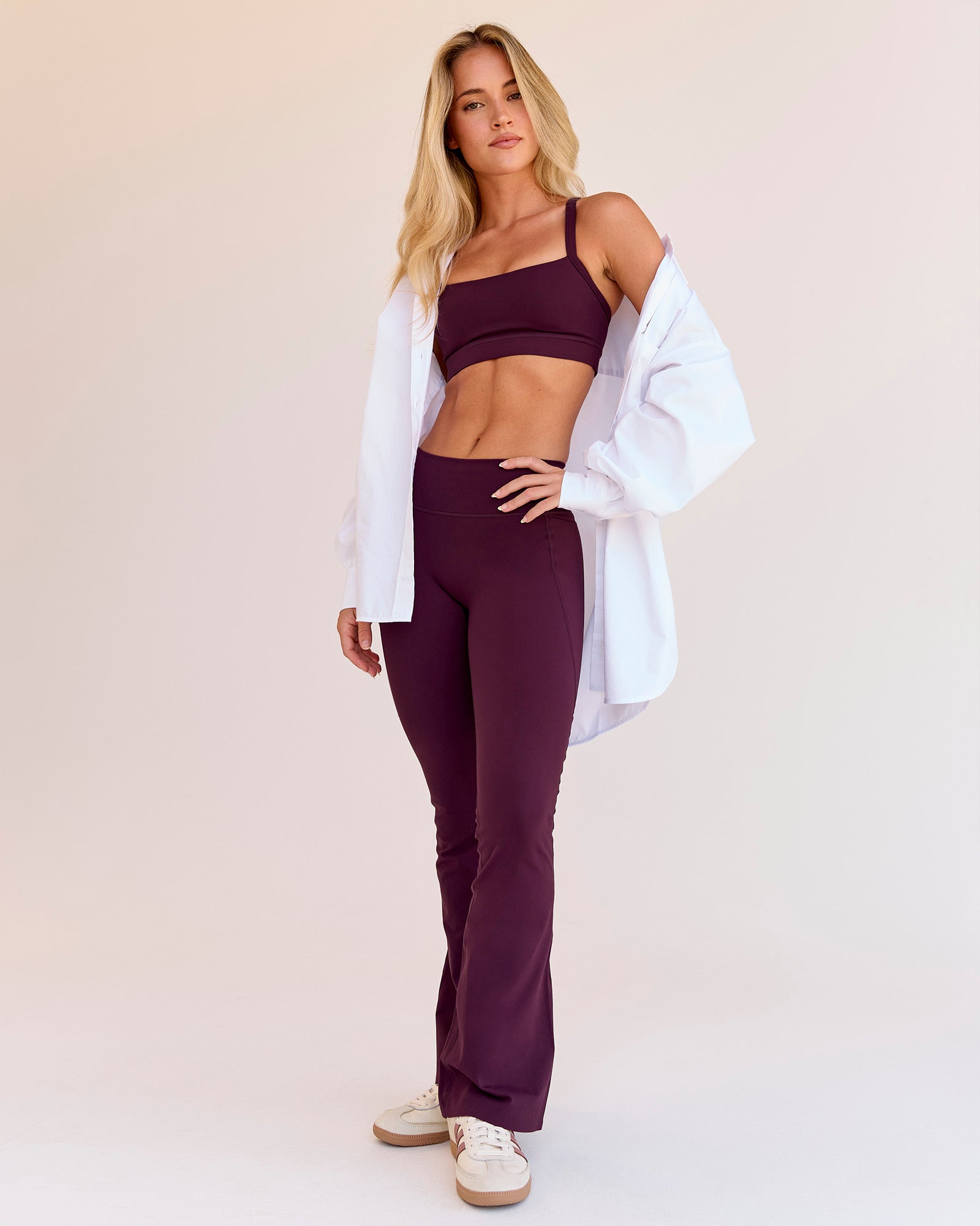 Woman wearing Fusion V-Contour High-Rise Flared Petite Legging Pockets - Cherry Lacquer | Model:Issy | Size:XS