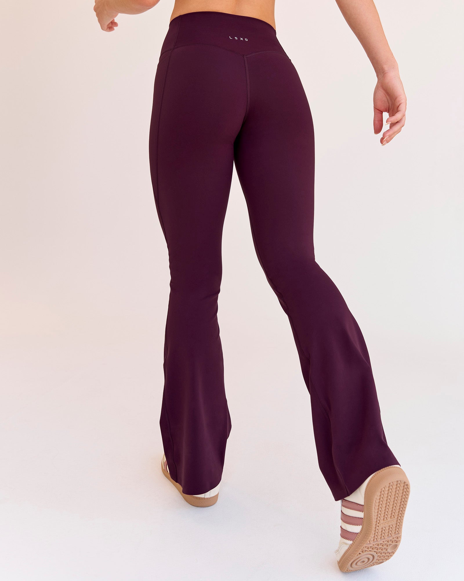 Woman wearing Fusion V-Contour High-Rise Flared Petite Legging Pockets - Cherry Lacquer | Model:Issy | Size:XS