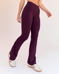 Woman wearing Fusion V-Contour High-Rise Flared Petite Legging Pockets - Cherry Lacquer | Model:Issy | Size:XS