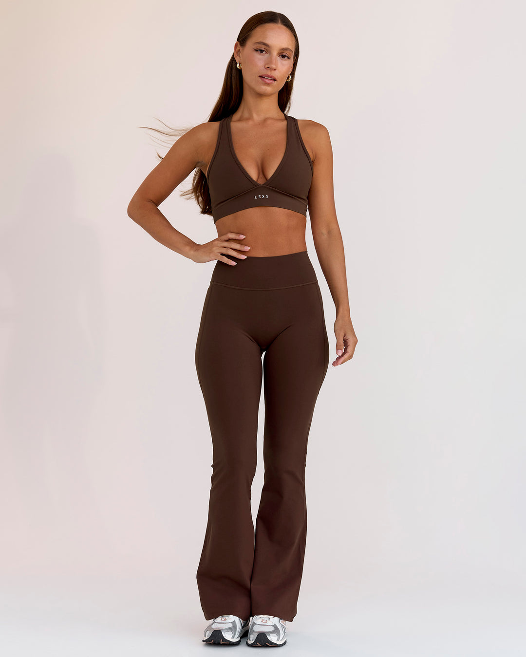 Woman wearing Fusion V-Contour High-Rise Flared Petite Legging Pockets - Hot Chocolate | Model:Brylee | Size:XS