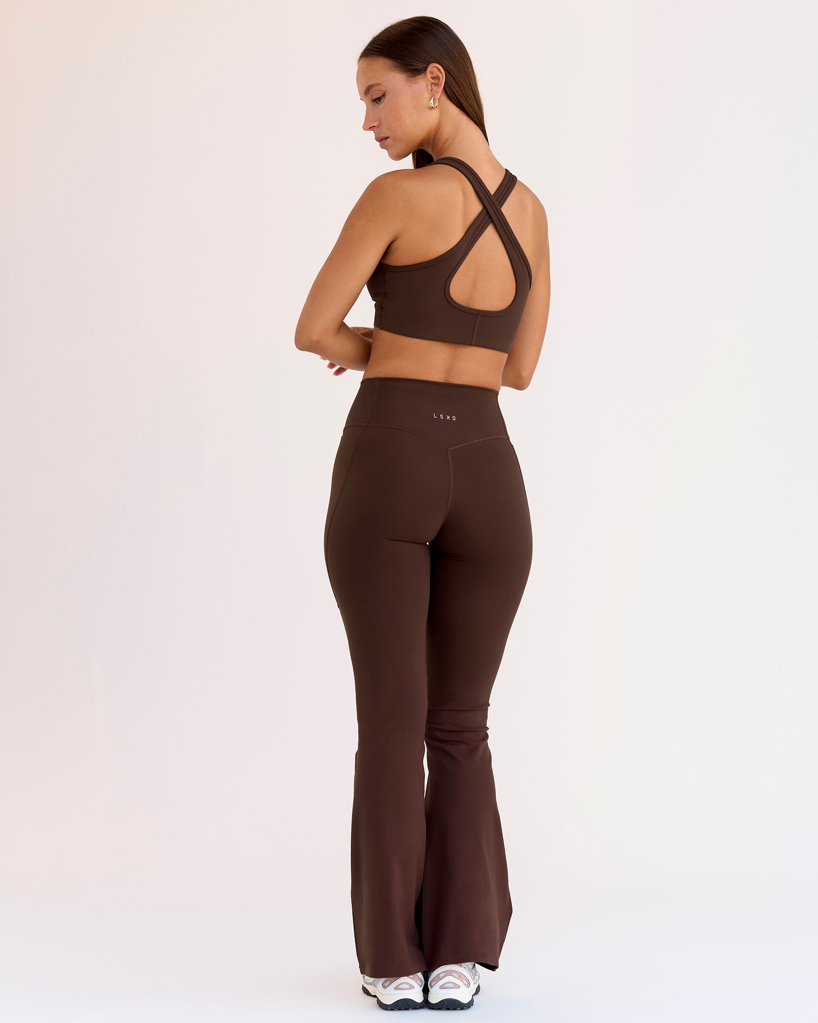 Woman wearing Fusion V-Contour High-Rise Flared Petite Legging Pockets - Hot Chocolate | Model:Brylee | Size:XS