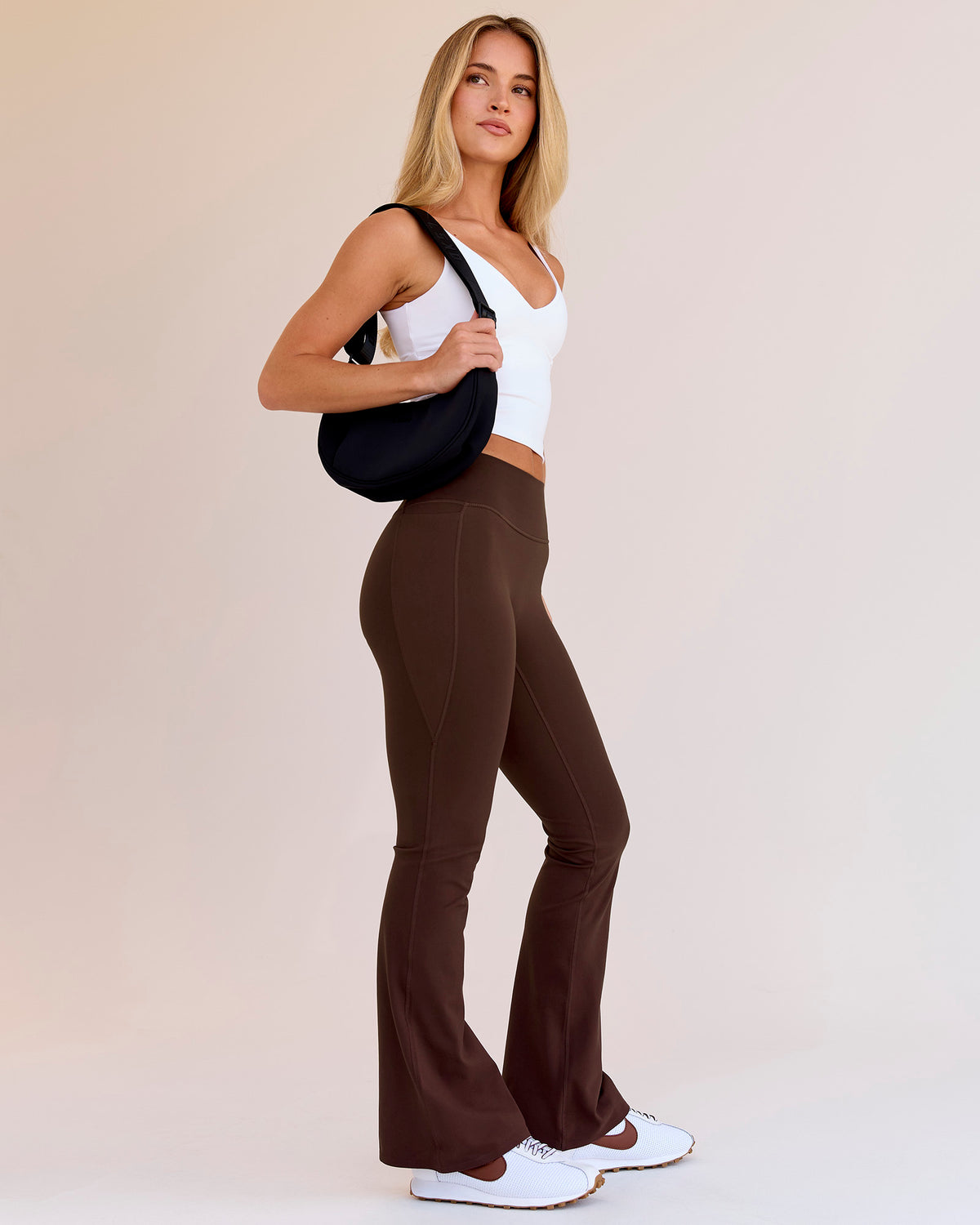 Woman wearing Fusion V-Contour High-Rise Flared Petite Legging Pockets - Hot Chocolate | Model:Issy | Size:XS