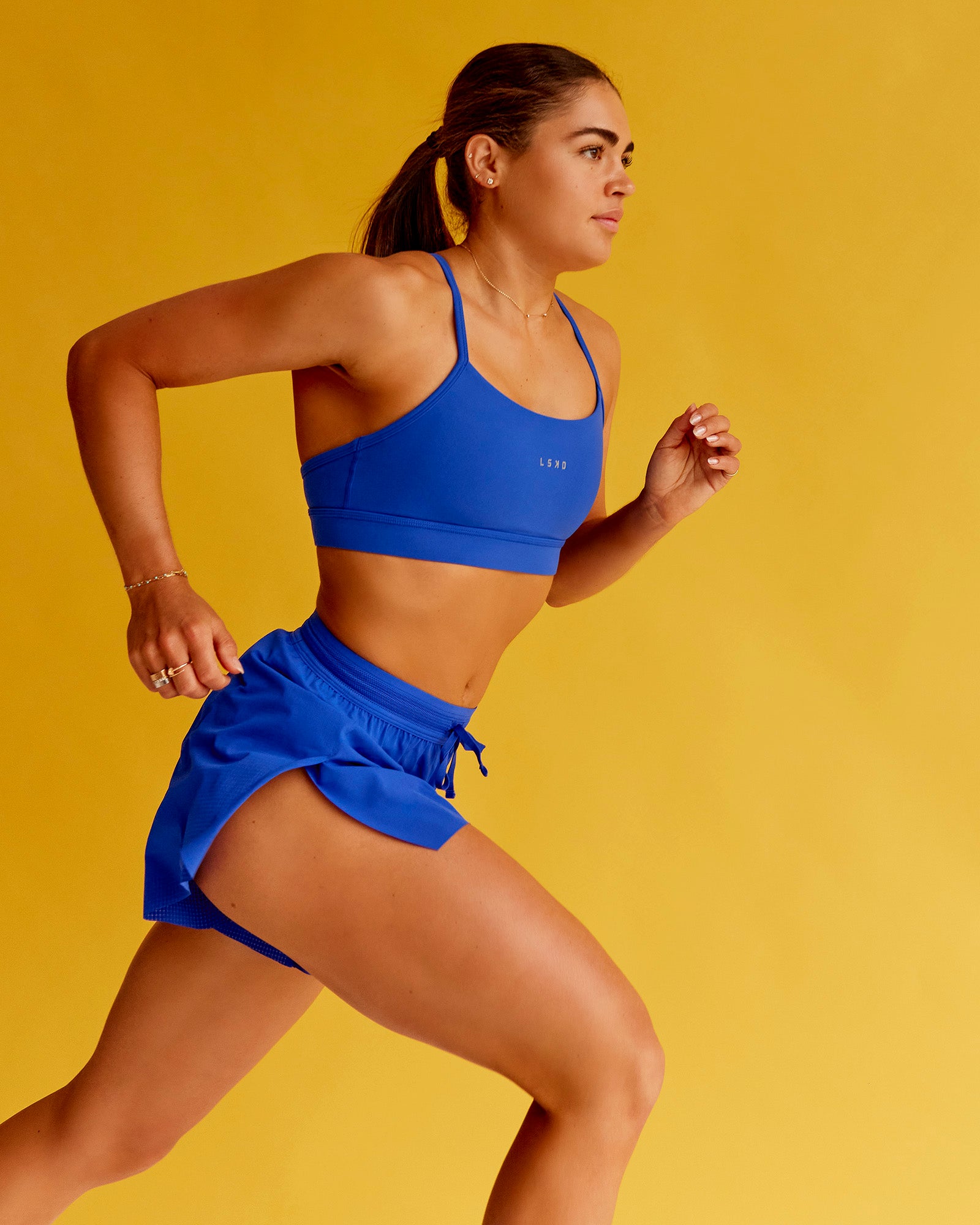 Woman wearing Lift Sports Bra - Electric Indigo | Model:Bella | Size:XS