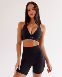 Woman wearing O.G Fusion Ultra High-Rise 6" Short Pockets - Black | Model:Eliza | Size:XS