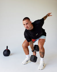 Man wearing Our Journey Heavyweight Oversized Tee - Black-Rainbow | Model:Tayden | Size:XS