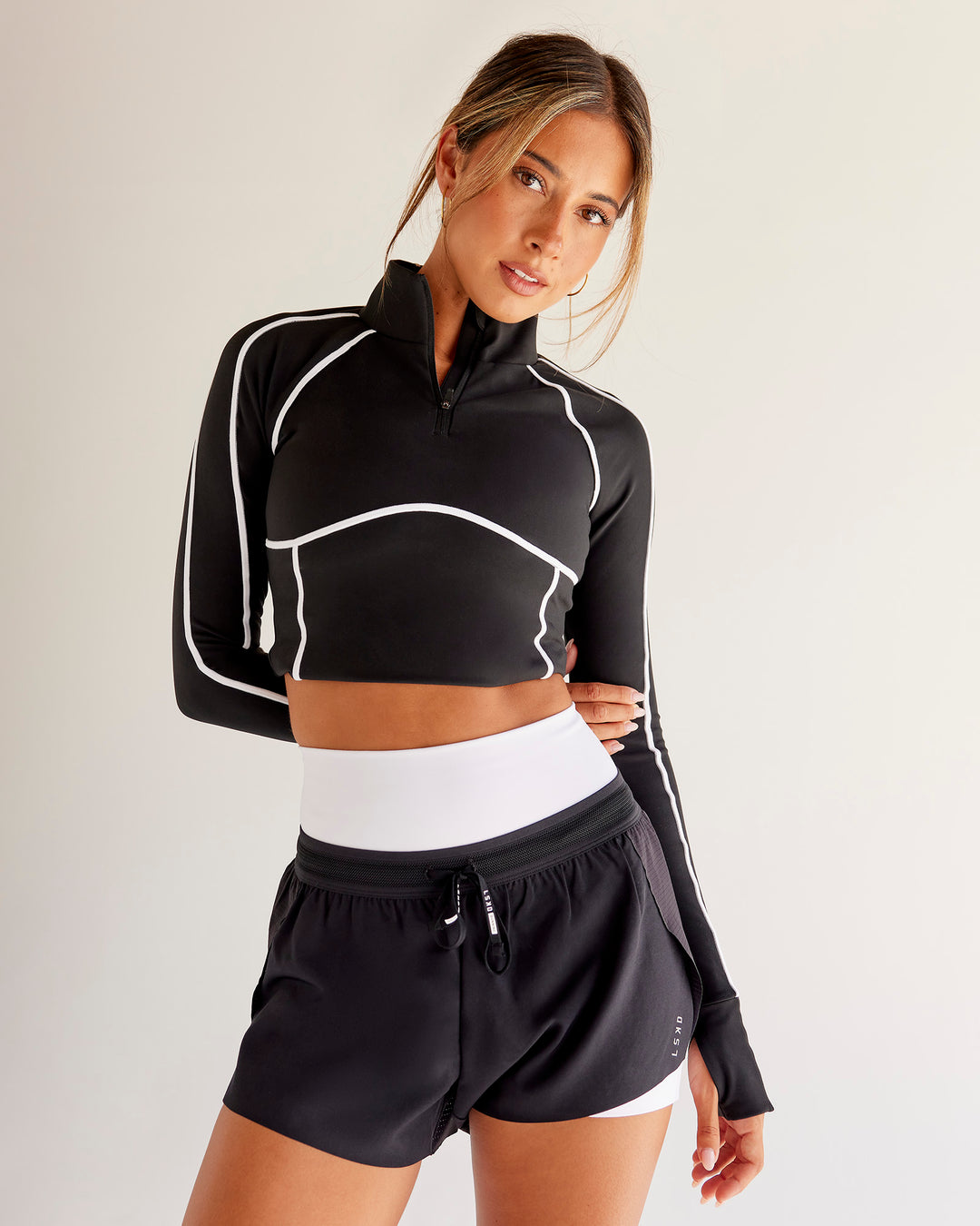 Woman wearing Power Quarter Zip Jacket - Black | Model:Charli | Size:XS