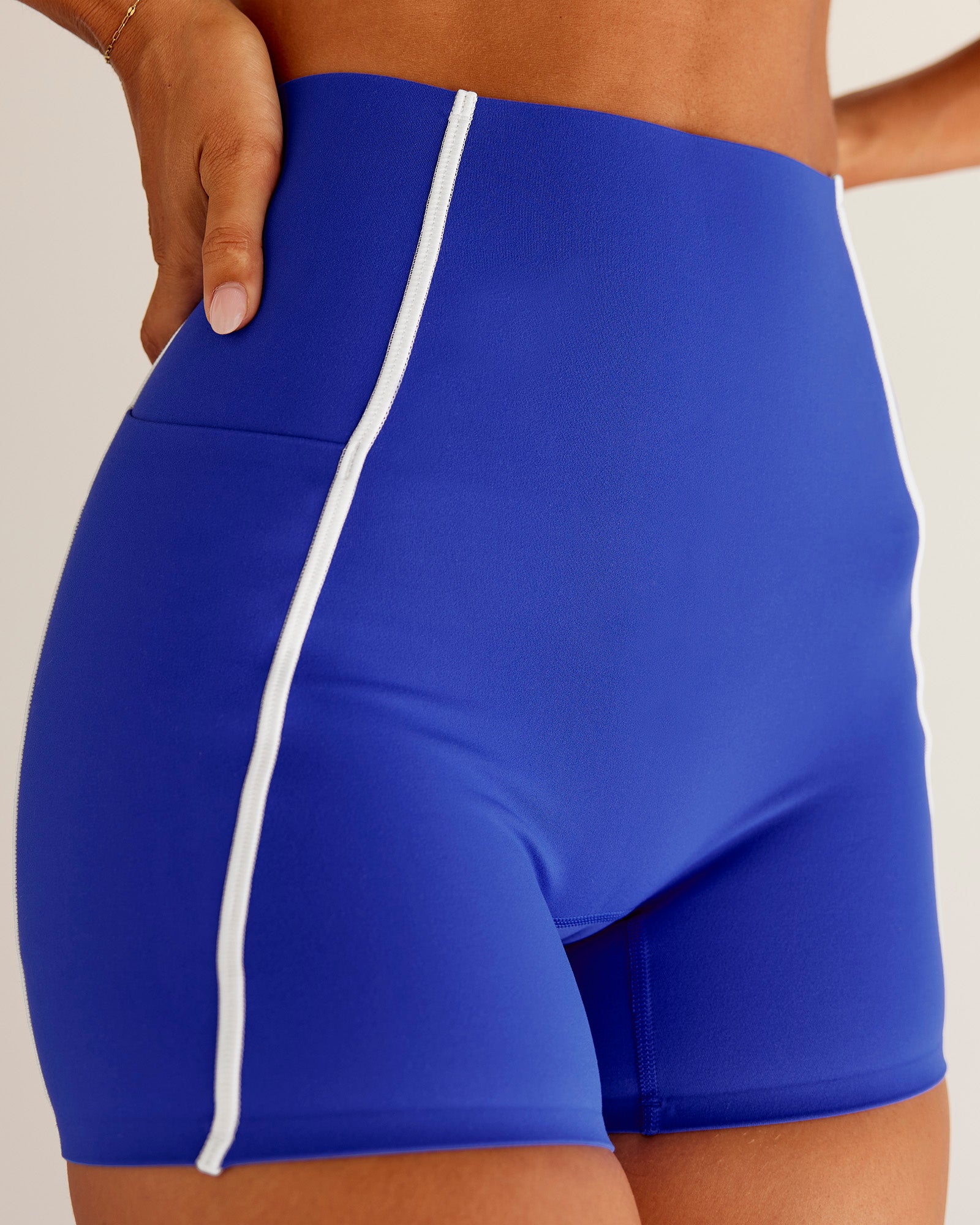 Woman wearing Power Ultra High-Rise 4" Short Pockets - Electric Indigo | Model:Charli | Size:XS