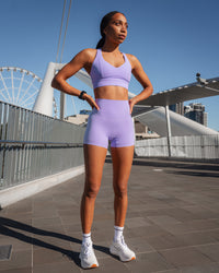 Woman wearing Sculpt Sports Bra - Violet Ray | Model:Txai | Size:XS