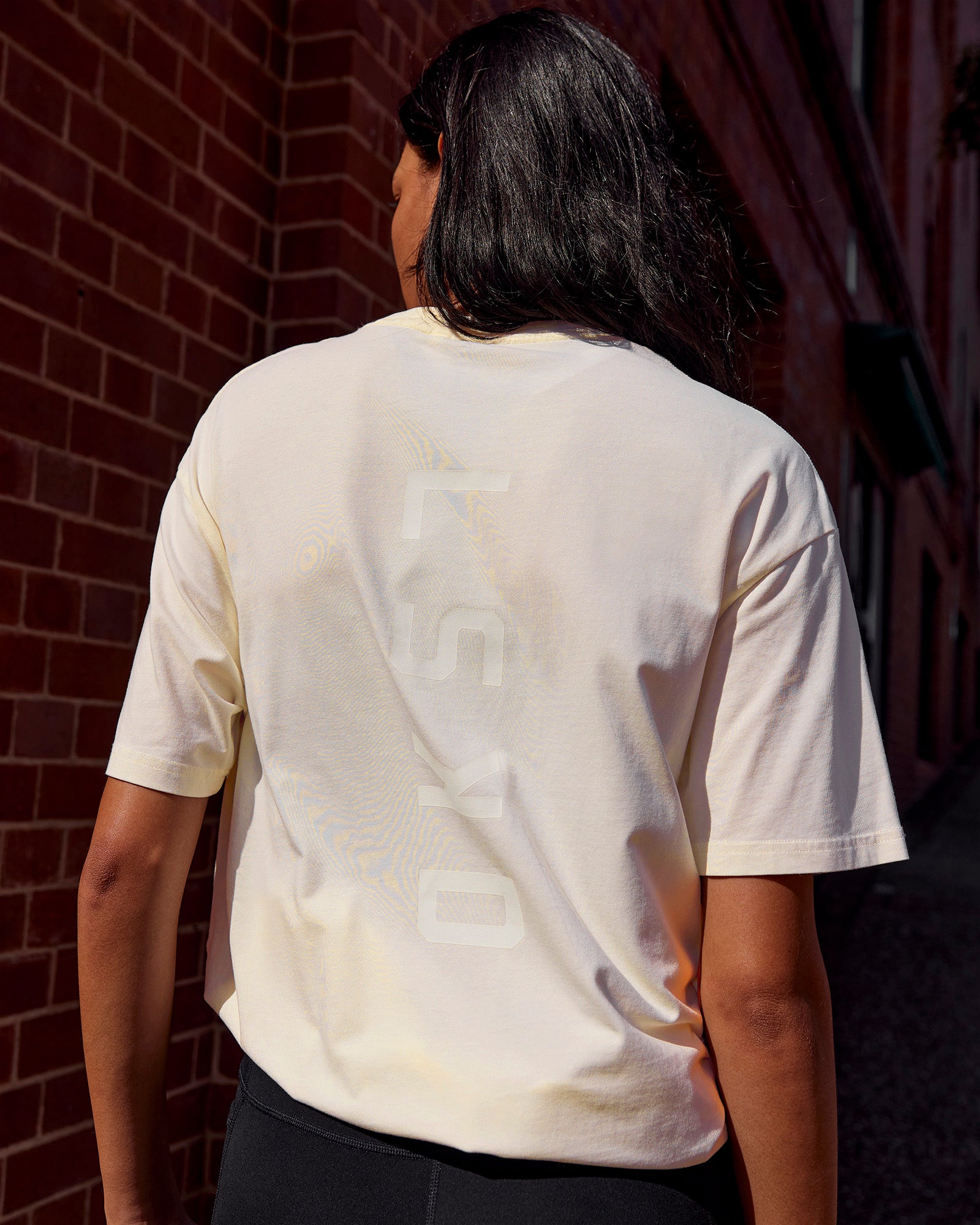Woman wearing Shadow Mode FLXCotton Oversized Tee - Off White Washed | Model:Alex | Size:XS