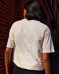 Woman wearing Shadow Mode FLXCotton Oversized Tee - Off White Washed | Model:Alex | Size:XS