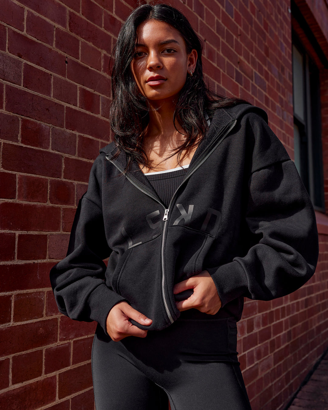 Woman wearing Shadow Mode Oversized Zip Through Hoodie - Black | Model:Alex | Size:XS