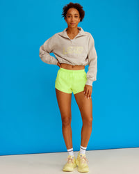 Woman wearing Slam Quarter Zip Sweater - Shale Beige-Lime Glo | Model:Txai | Size:XS