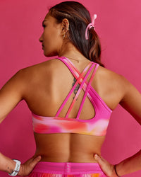 Woman wearing Stamina Rise Sports Bra - Pink Glow Print | Model:Steph | Size:XS