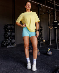 Woman wearing Unfit Club FLXCotton Oversized Tee - Yellow Fizz Washed-Ultra Fuchsia | Model:Abbey | Size:XS
