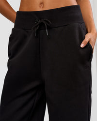 Woman wearing Go-To Wide Leg Track Pant Tall - Black | Model:Georgia | Size:XS