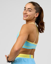 Woman wearing Breeze Sports Bra - Baltic Sea-Lemon | Model:Grace | Size:XS