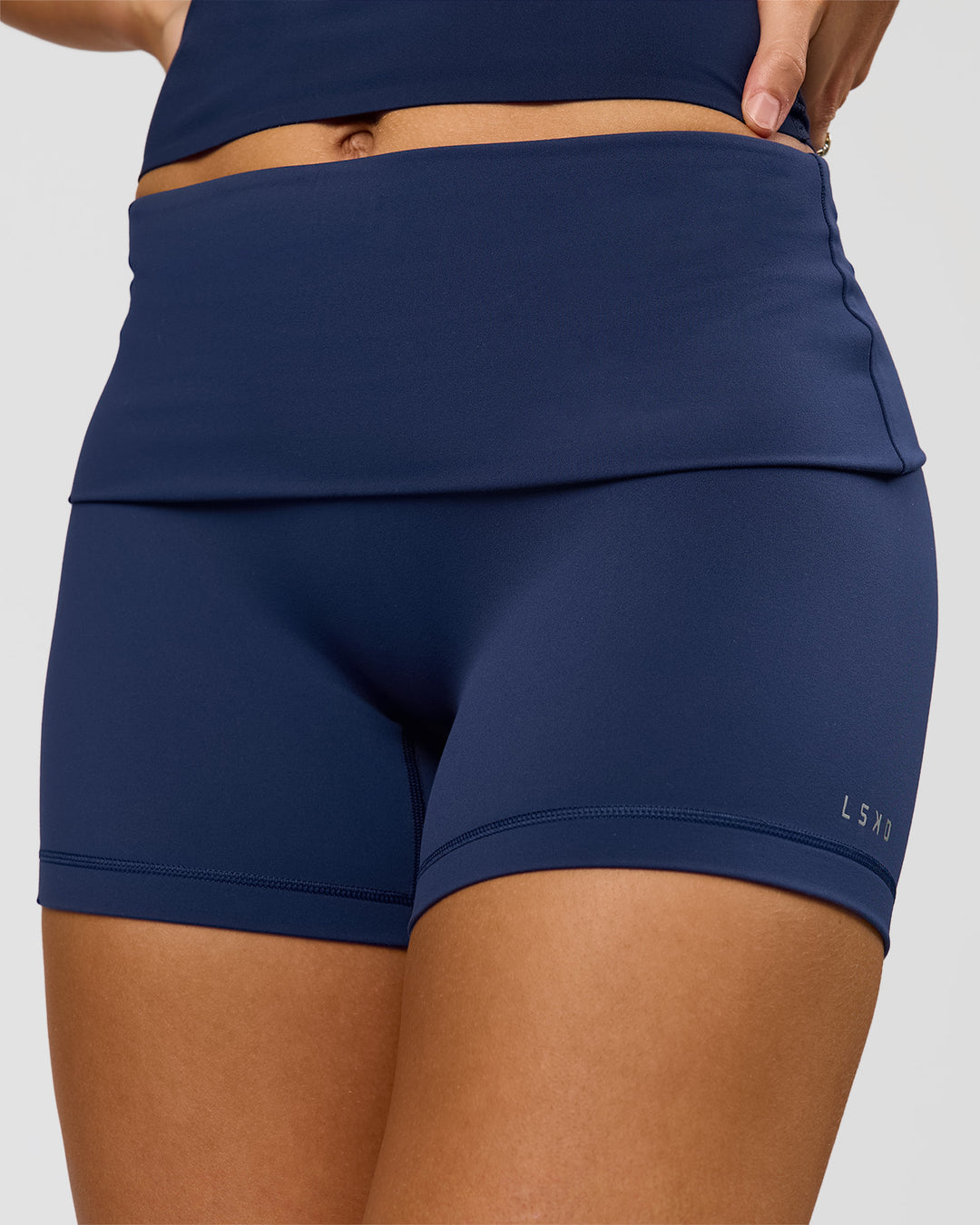 Woman wearing Groovy High Rise Fold Over 4" Short - Future Navy | Model:Grace | Size:XS
