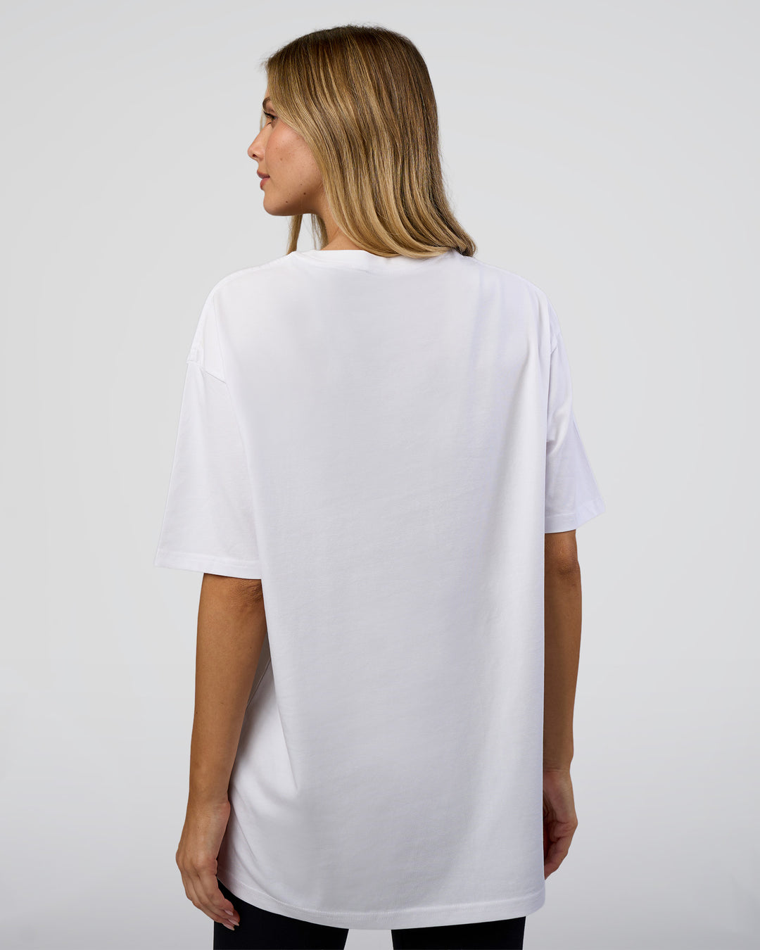 Woman wearing 1% Better Every Day EST FLXCotton Oversized Tee - White | Model:Leilani | Size:XS