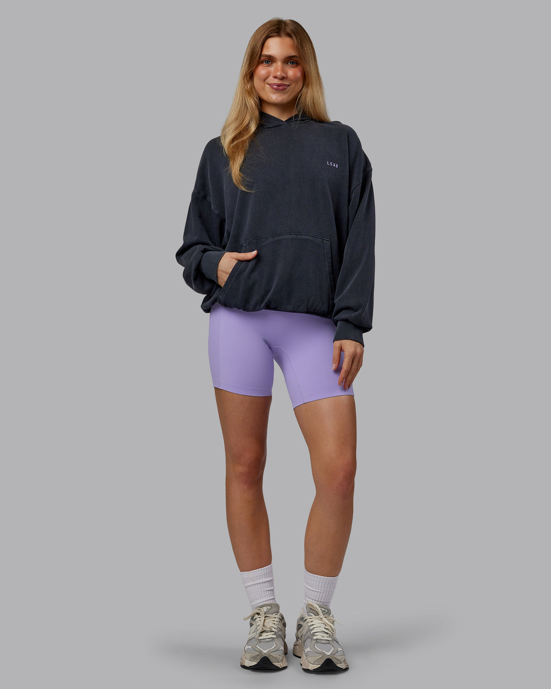 Woman wearing 1% Better Value Series Oversized Hoodie - Black-Violet Ray | Model:Emilie | Size:XS