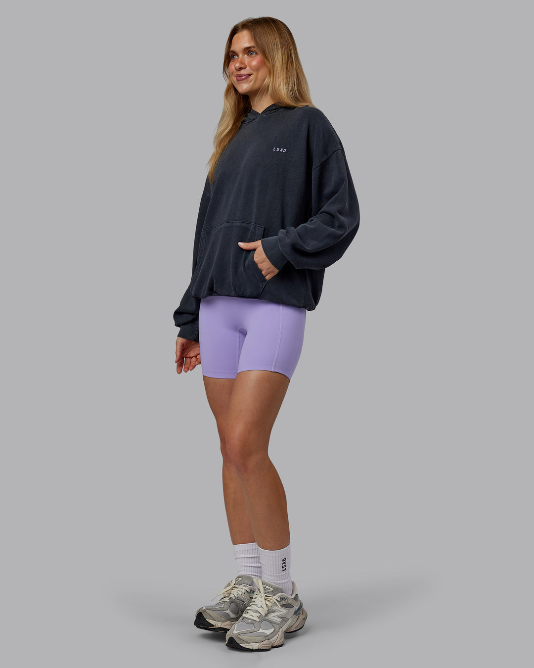 Woman wearing 1% Better Value Series Oversized Hoodie - Black-Violet Ray | Model:Emilie | Size:XS