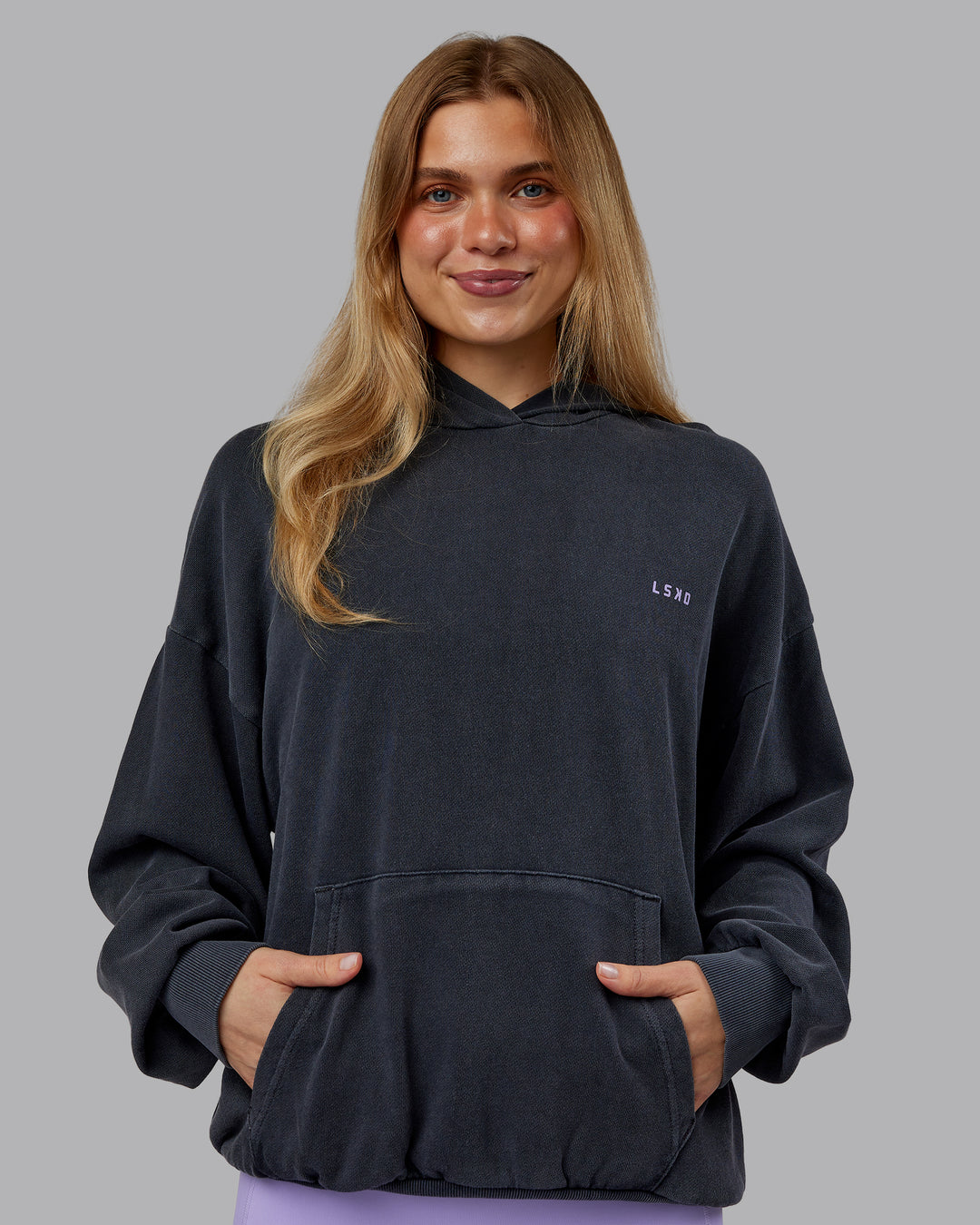 Woman wearing 1% Better Value Series Oversized Hoodie - Black-Violet Ray | Model:Emilie | Size:XS