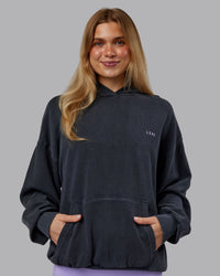 Woman wearing 1% Better Value Series Oversized Hoodie - Black-Violet Ray | Model:Emilie | Size:XS