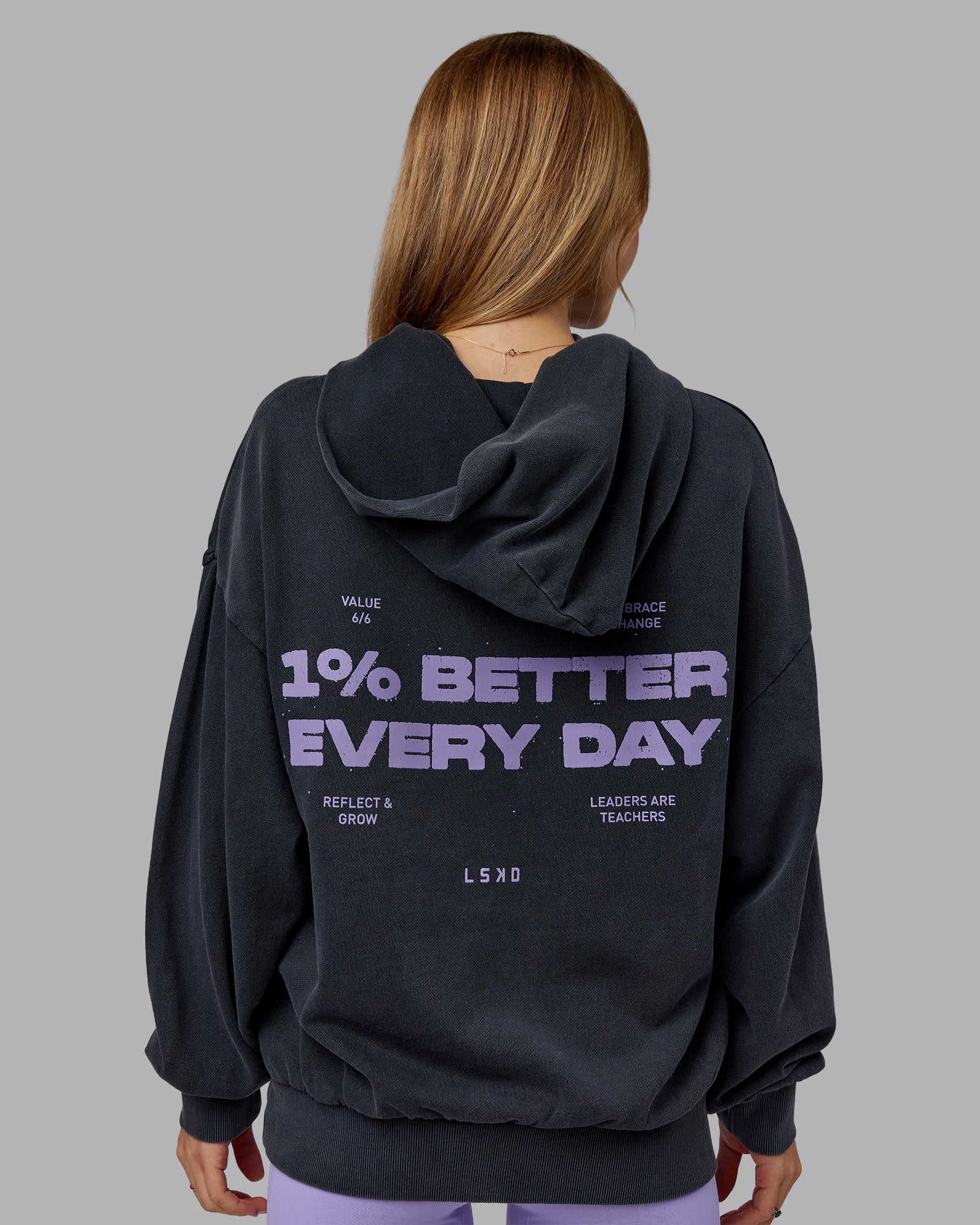 Woman wearing 1% Better Value Series Oversized Hoodie - Black-Violet Ray | Model:Emilie | Size:XS