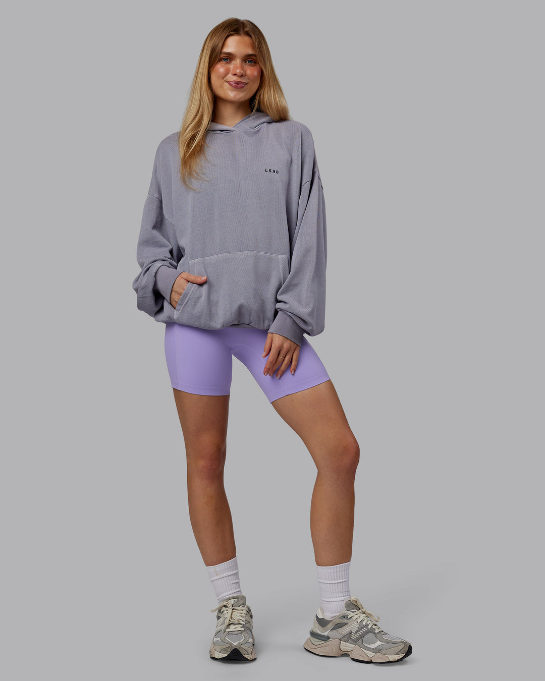 Woman wearing 1% Better Value Series Oversized Hoodie - Violet Ray-Black | Model:Emilie | Size:XS