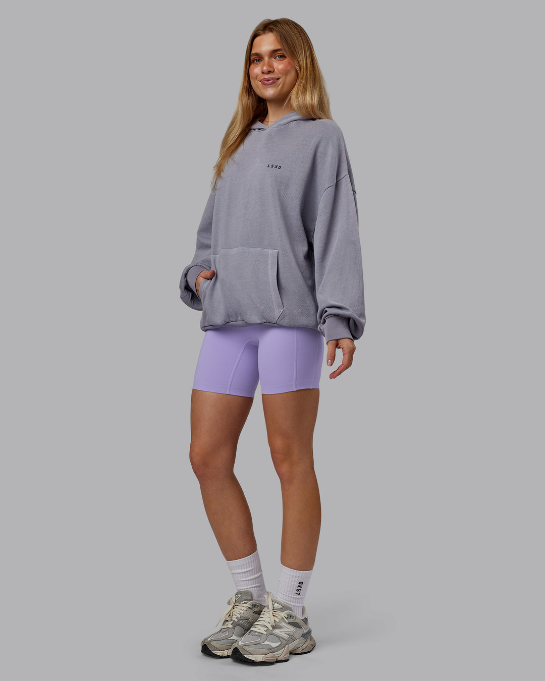 Woman wearing 1% Better Value Series Oversized Hoodie - Violet Ray-Black | Model:Emilie | Size:XS
