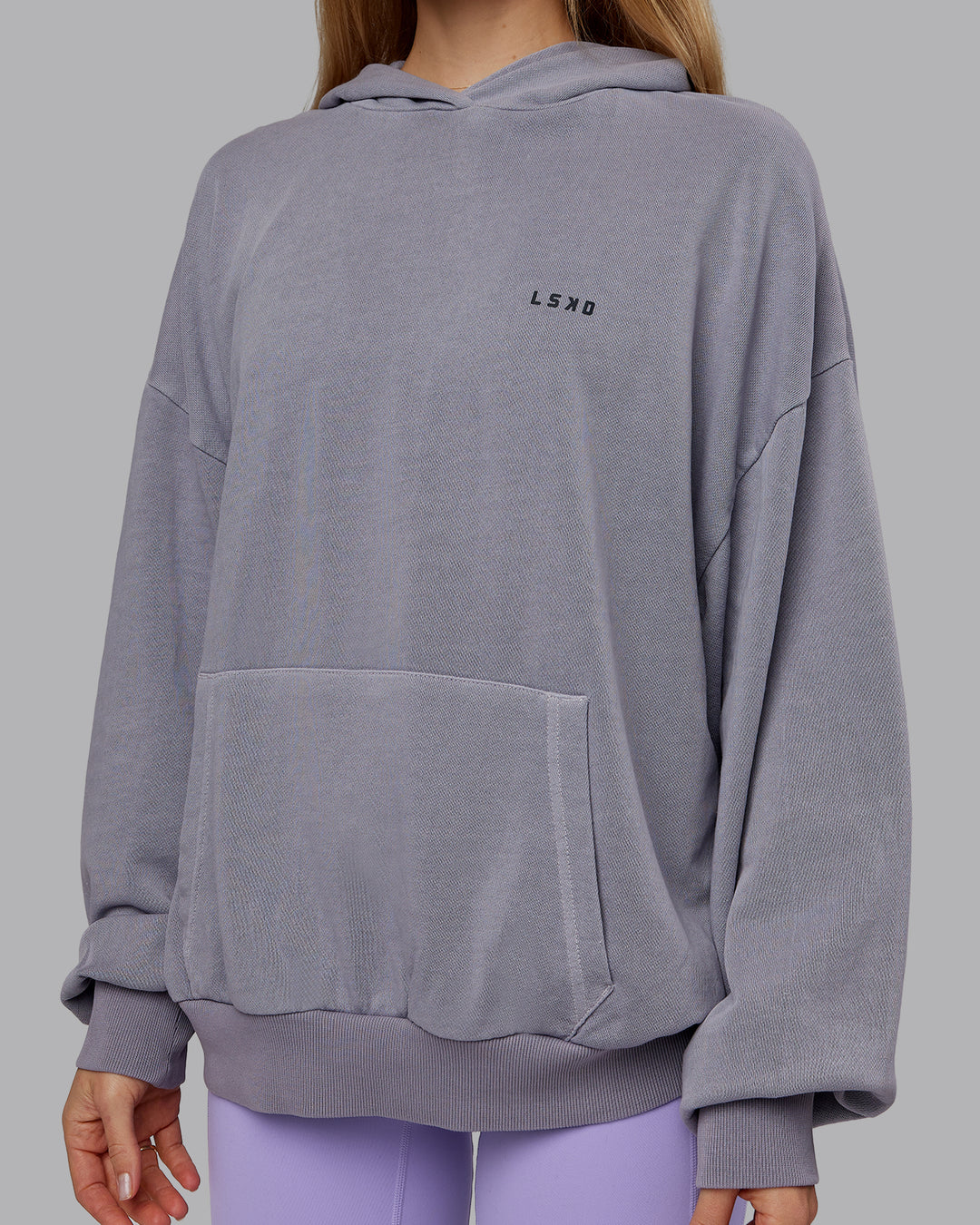 Woman wearing 1% Better Value Series Oversized Hoodie - Violet Ray-Black | Model:Emilie | Size:XS