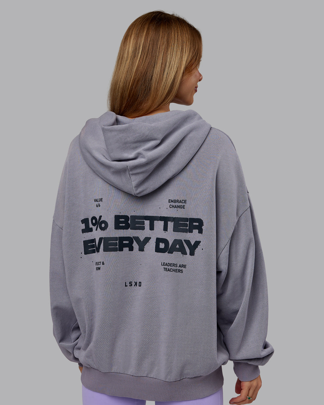 Woman wearing 1% Better Value Series Oversized Hoodie - Violet Ray-Black | Model:Emilie | Size:XS