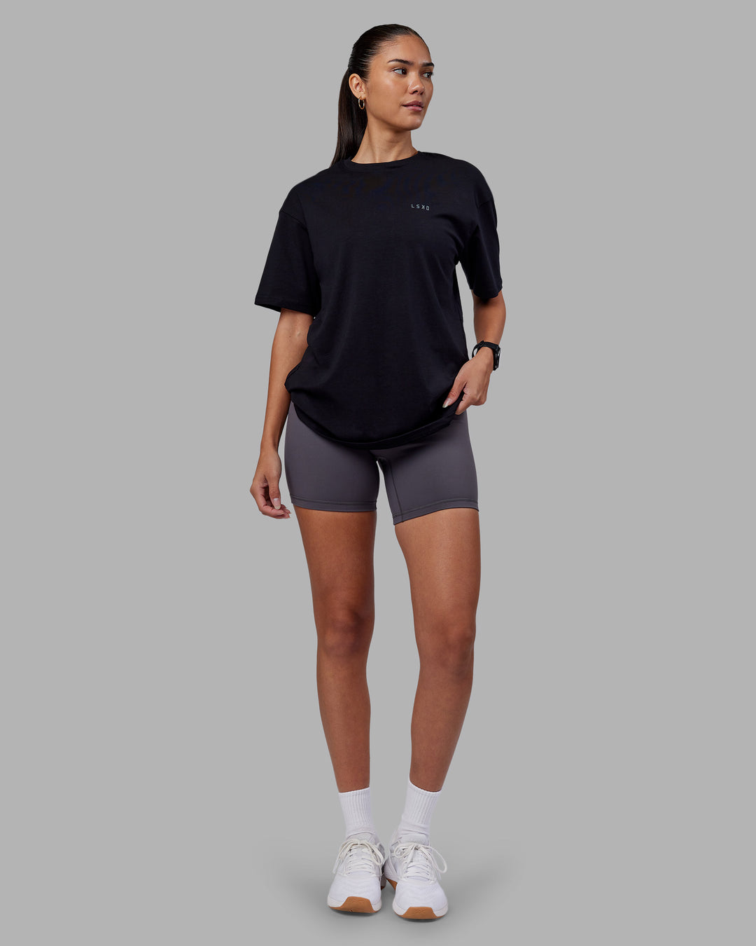 Woman wearing 1% Better Value Series FLXCotton Tee Oversize - Black-Black | Model:Rhiley | Size:XS