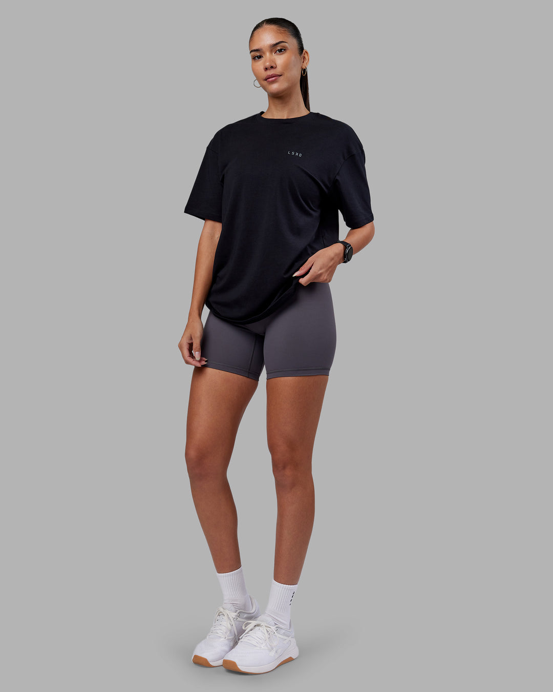 Woman wearing 1% Better Value Series FLXCotton Tee Oversize - Black-Black | Model:Rhiley | Size:XS